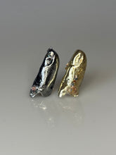 3D-printed resin finger sleeves with metal-like finish and gemstone inlays, designed to be worn on the index and ring fingers.